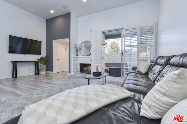 living room featuring a brick fireplace