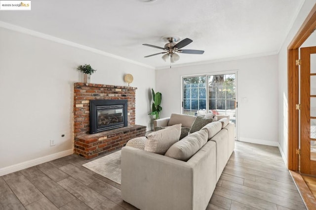 living room with ornamental molding, a brick fireplace, and hardwood / wood-style floors