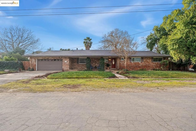 ranch-style home featuring a garage and a front lawn