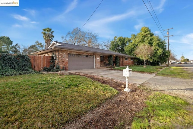 ranch-style house with a garage and a front lawn