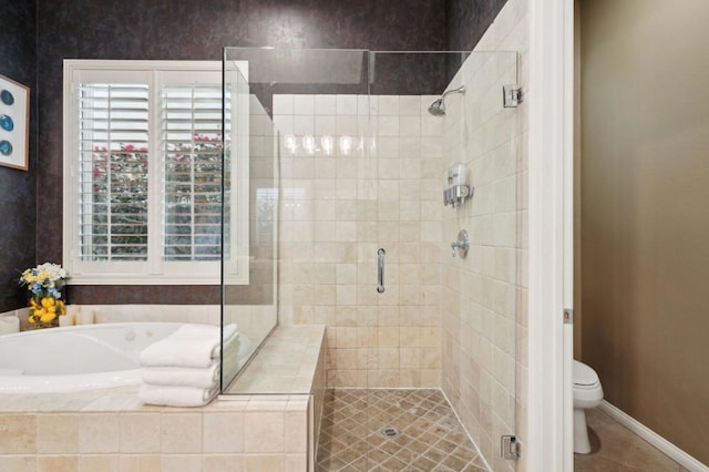 bathroom featuring shower with separate bathtub and toilet