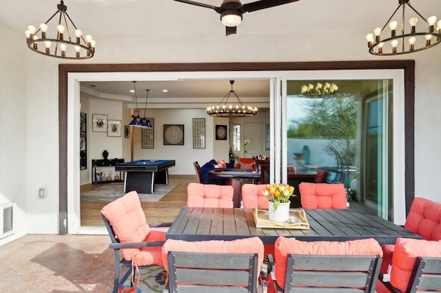 dining room with ceiling fan with notable chandelier