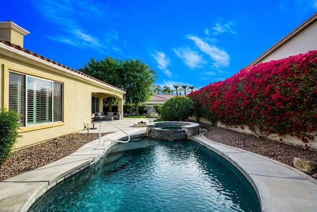 view of pool featuring a patio and an in ground hot tub