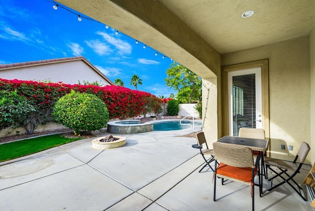 view of patio / terrace with a pool with hot tub