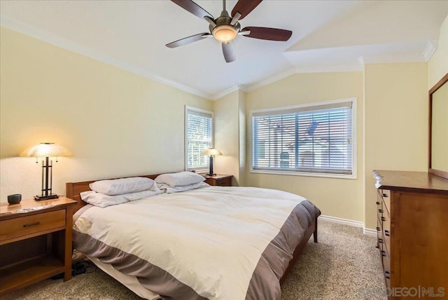 carpeted bedroom featuring crown molding, ceiling fan, and vaulted ceiling