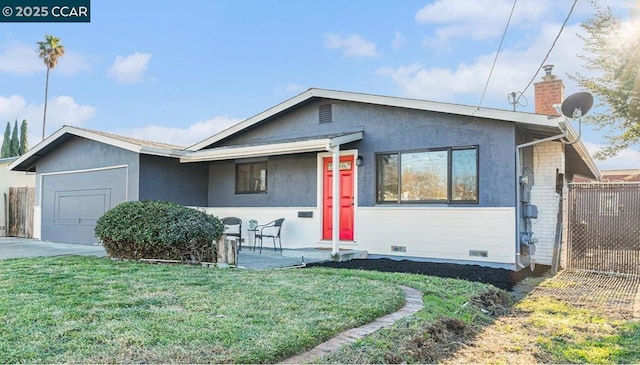 view of front of property featuring a garage and a front lawn