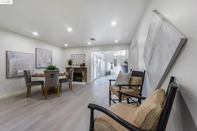 sitting room featuring a fireplace and light hardwood / wood-style floors