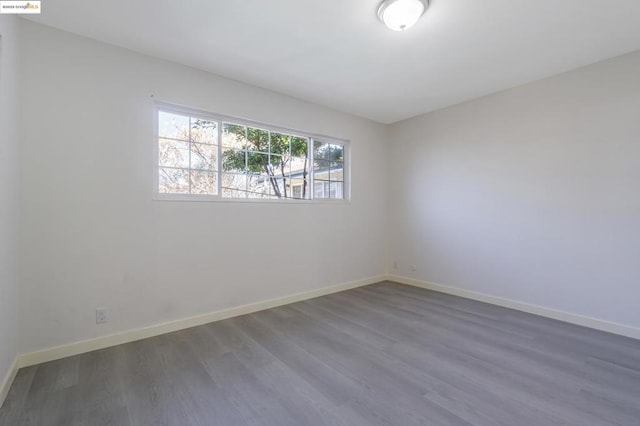 empty room with dark hardwood / wood-style floors