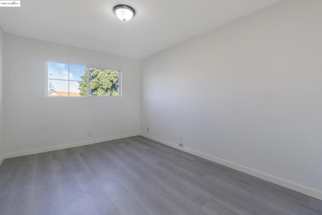 empty room featuring dark hardwood / wood-style flooring