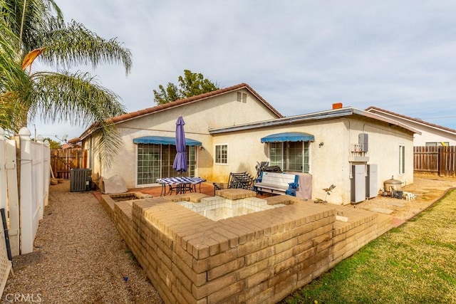 rear view of property featuring a patio area, a fenced backyard, cooling unit, and stucco siding