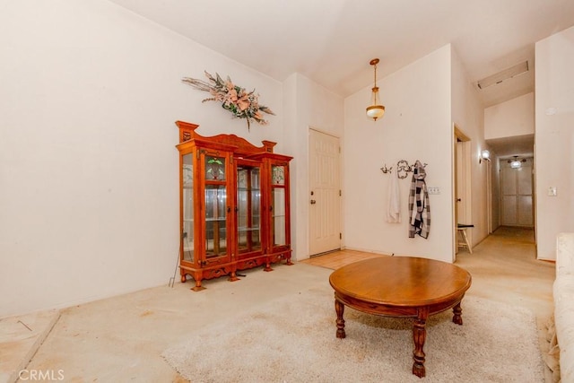 sitting room with lofted ceiling and carpet