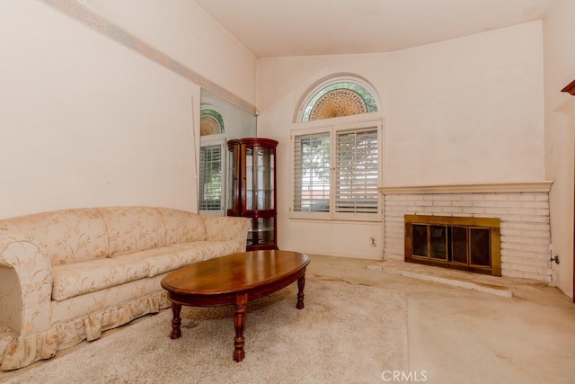 carpeted living room with a brick fireplace