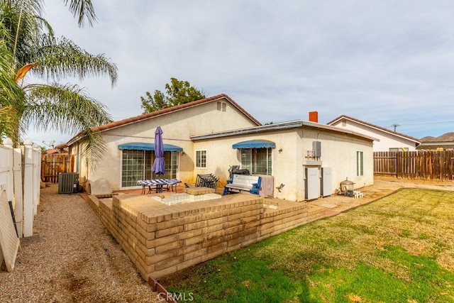 rear view of property with a patio area, a fenced backyard, central AC unit, and stucco siding