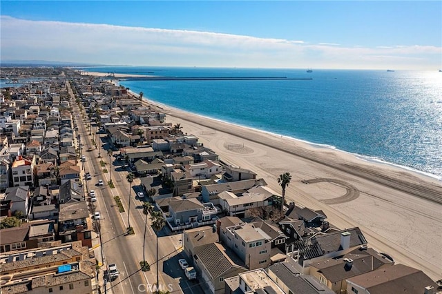 drone / aerial view featuring a water view and a beach view