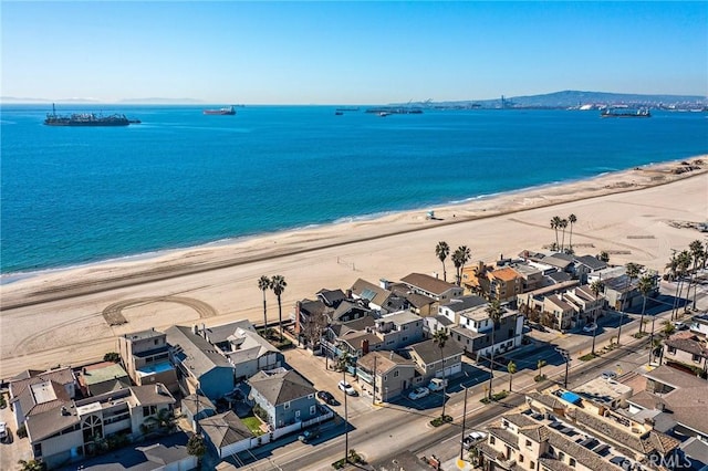 drone / aerial view with a water view and a beach view