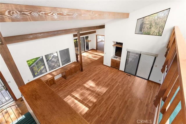 living room with hardwood / wood-style floors and lofted ceiling with beams