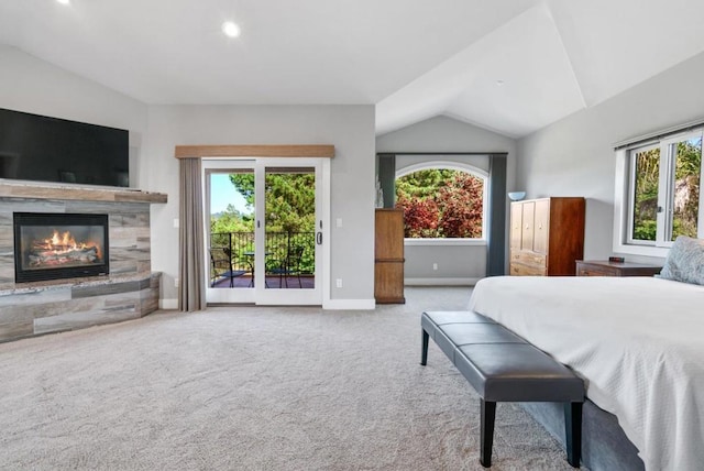 carpeted bedroom featuring a fireplace, access to exterior, vaulted ceiling, and multiple windows