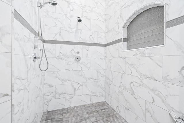 bathroom with a tile shower