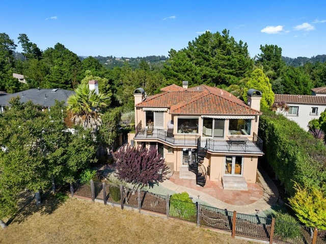 rear view of house featuring a patio area and a balcony