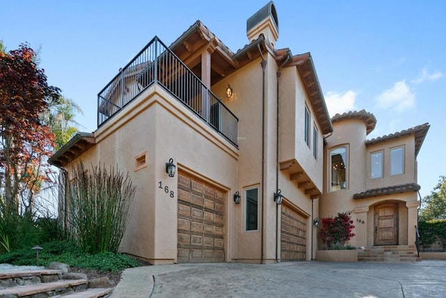 view of front of house featuring a garage and a balcony