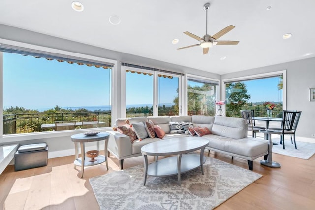 sunroom featuring ceiling fan