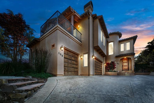 view of front of property with a balcony and a garage