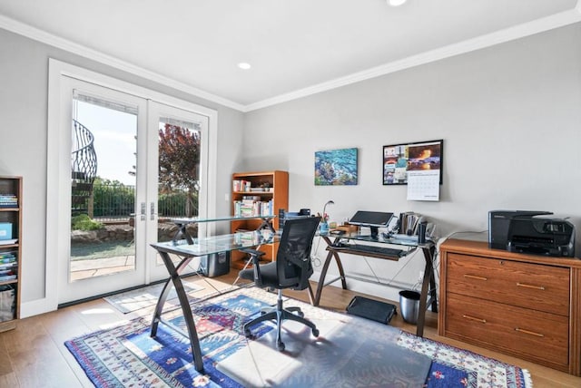 home office with crown molding, light hardwood / wood-style floors, and french doors