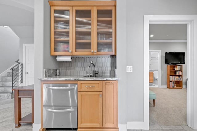 bar with sink, light colored carpet, light stone countertops, and backsplash