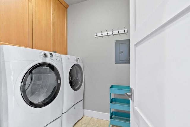 clothes washing area with cabinets, light tile patterned floors, washing machine and clothes dryer, and electric panel