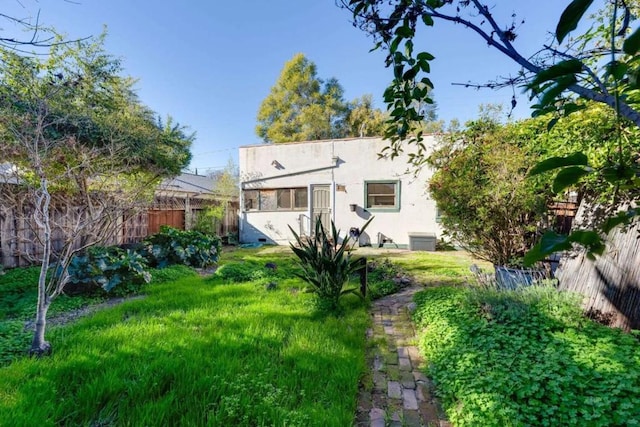 rear view of house featuring a yard