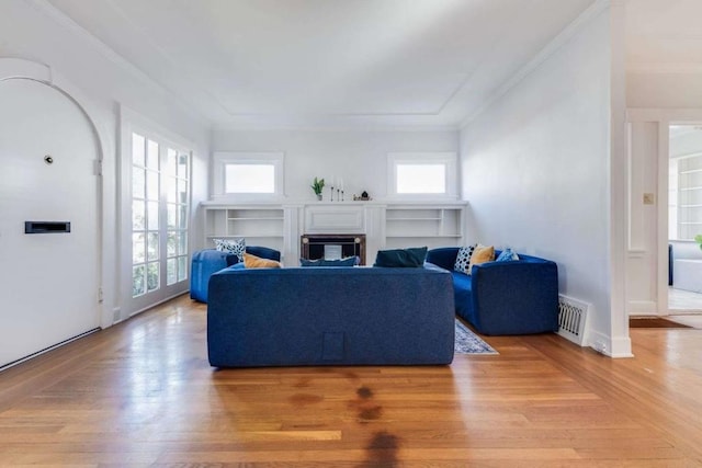 living room featuring crown molding and hardwood / wood-style flooring