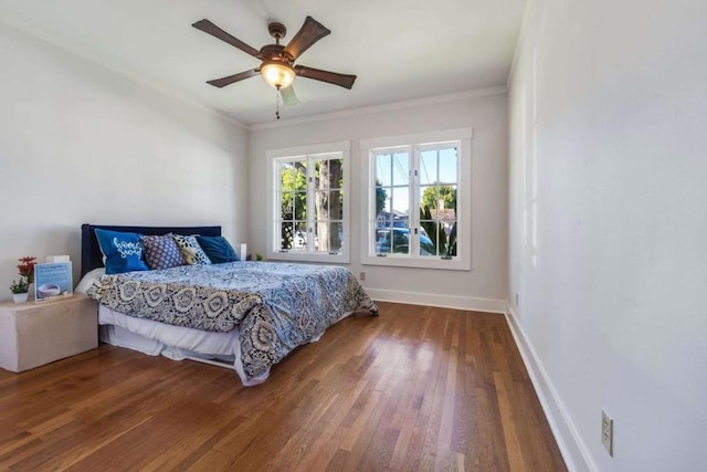 bedroom with hardwood / wood-style flooring, ceiling fan, and ornamental molding