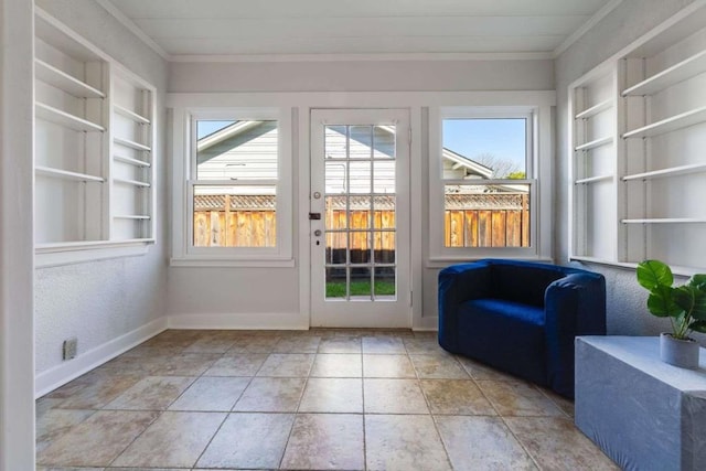 entryway featuring ornamental molding and built in shelves