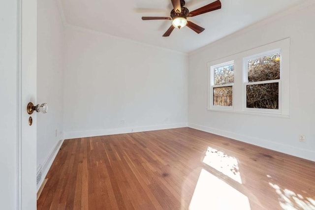 spare room with crown molding, hardwood / wood-style floors, and ceiling fan