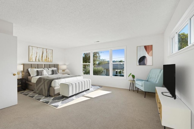 carpeted bedroom featuring a textured ceiling