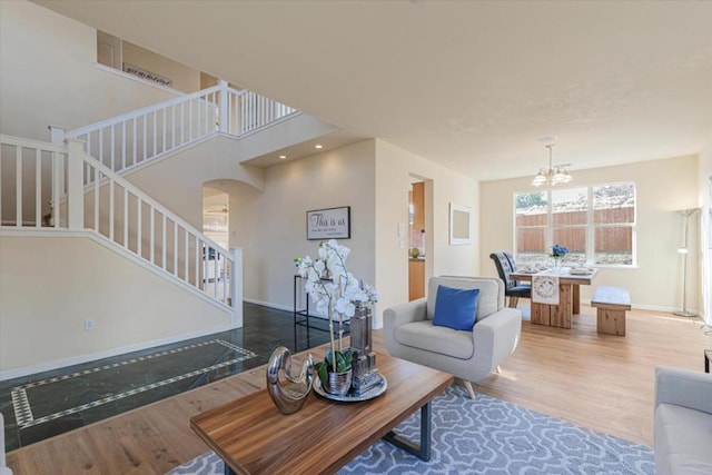 living room with hardwood / wood-style flooring and a chandelier