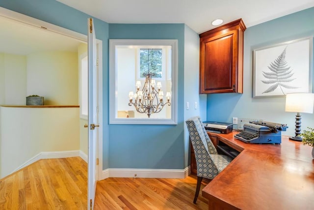 office space featuring a chandelier and light hardwood / wood-style floors