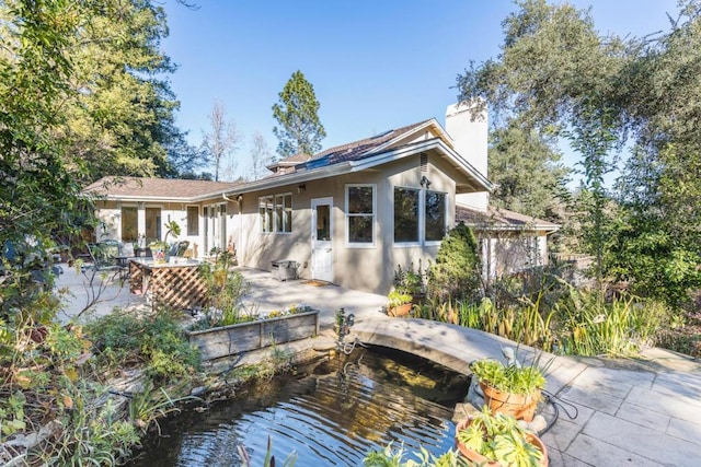 back of house with a patio area