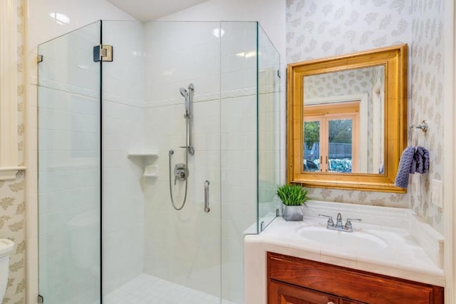 bathroom with vanity, a shower with shower door, and toilet