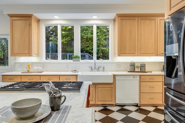 kitchen with sink, dishwasher, black fridge, stainless steel gas stovetop, and light brown cabinets