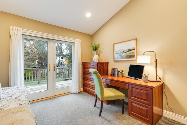 home office featuring lofted ceiling, light colored carpet, and french doors