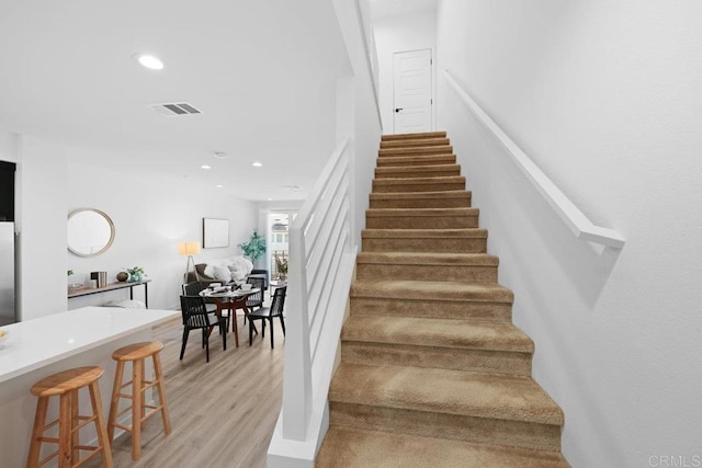 stairs featuring wood-type flooring