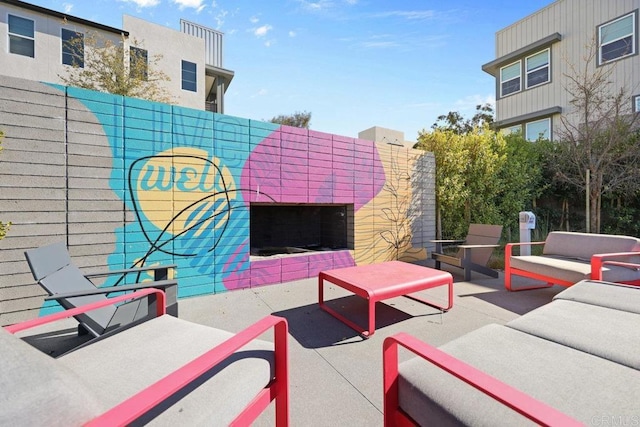 view of patio / terrace with an outdoor living space with a fireplace