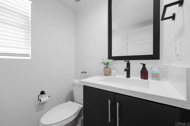 bathroom featuring vanity and toilet