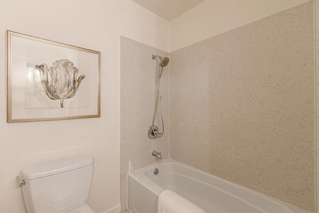 bathroom featuring toilet and tiled shower / bath