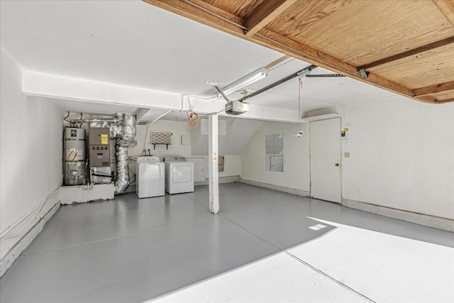 garage featuring heating unit, a garage door opener, water heater, and washing machine and clothes dryer