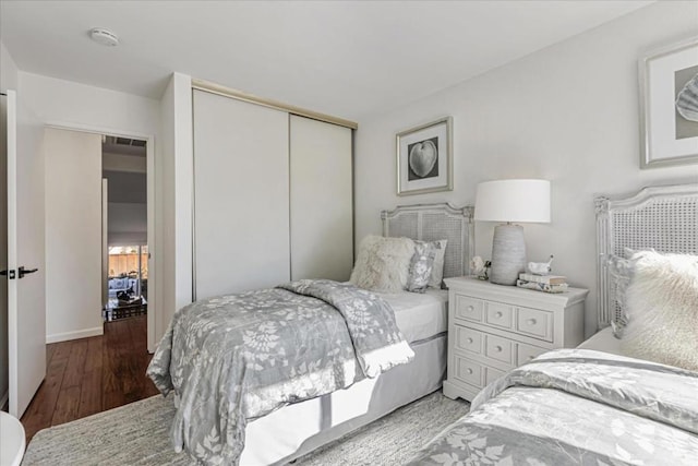 bedroom with hardwood / wood-style flooring and a closet