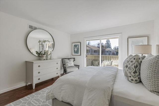 bedroom featuring access to exterior and dark hardwood / wood-style floors