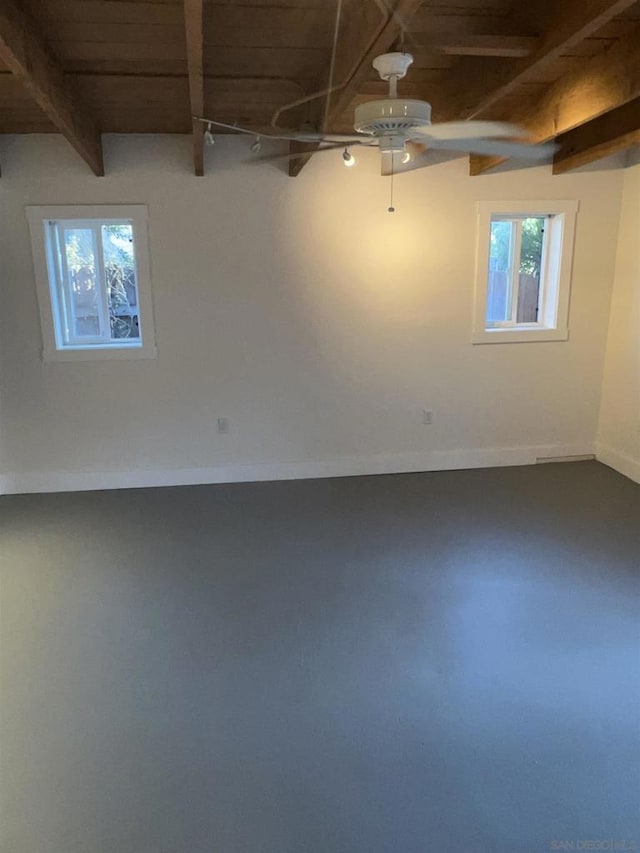 basement featuring wood ceiling and ceiling fan