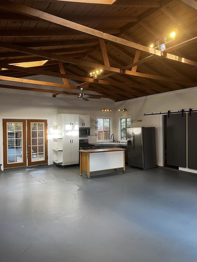 garage with sink, wood ceiling, and stainless steel fridge with ice dispenser